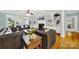Relaxing living room with hardwood floors, access to a patio, and built-in shelving at 10811 Old Tayport Pl, Charlotte, NC 28277