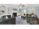 Bright living room featuring a fireplace, built-in shelving, and hardwood floors at 10811 Old Tayport Pl, Charlotte, NC 28277