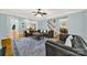 Spacious living room with hardwood floors, comfortable seating, and a view into the dining room at 10811 Old Tayport Pl, Charlotte, NC 28277