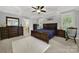 Spacious main bedroom with dark wood furniture and en-suite bathroom at 10811 Old Tayport Pl, Charlotte, NC 28277