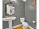 Elegant powder room featuring a pedestal sink and ornate mirror at 10811 Old Tayport Pl, Charlotte, NC 28277