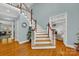 Elegant wooden staircase with white railing at 10811 Old Tayport Pl, Charlotte, NC 28277