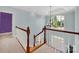 Elegant staircase with wooden railing and large window at 10811 Old Tayport Pl, Charlotte, NC 28277