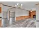 Spacious living room features wood-look flooring, chandelier, and fireplace at 1106 Safeway Dr, Gastonia, NC 28056