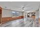 Open-concept living area with wood-look flooring, ceiling fan, natural light, and view into the kitchen at 1106 Safeway Dr, Gastonia, NC 28056