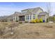 Exterior view of home showcasing a backyard with a stone walkway, patio area, and well-maintained landscaping at 11223 Wescott Hill Dr, Huntersville, NC 28078