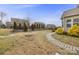 Landscaped backyard features a stone pathway and mature trees at 11223 Wescott Hill Dr, Huntersville, NC 28078
