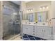 Bright bathroom features double sink vanity, glass shower, modern fixtures and a decorative rug at 11223 Wescott Hill Dr, Huntersville, NC 28078