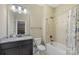 Full bathroom features a tiled shower and tub, granite vanity top, and updated fixtures at 11223 Wescott Hill Dr, Huntersville, NC 28078