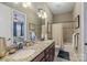 Bathroom featuring double sinks with granite countertop and a bathtub shower combination with tile surround at 11223 Wescott Hill Dr, Huntersville, NC 28078