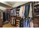 Spacious walk-in closet with custom wood shelving and ample storage for clothes and accessories at 11223 Wescott Hill Dr, Huntersville, NC 28078