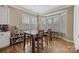 Bright dining area with hardwood floors, large bay window offering natural light, and table set with chairs at 11223 Wescott Hill Dr, Huntersville, NC 28078