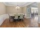 A formal dining area featuring decorative chandelier lighting, wainscoting, and hardwood floors at 11223 Wescott Hill Dr, Huntersville, NC 28078