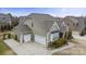 An exterior view reveals a three car garage and tasteful design at 11223 Wescott Hill Dr, Huntersville, NC 28078