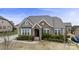 Charming home exterior featuring stone accents, manicured bushes, and a neatly landscaped front yard at 11223 Wescott Hill Dr, Huntersville, NC 28078