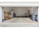 Open garage space with storage cabinets, a ladder, a treadmill, and a gray garbage container at 11223 Wescott Hill Dr, Huntersville, NC 28078
