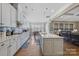 Open kitchen layout with a large center island, white cabinets, stainless appliances, and hardwood floors at 11223 Wescott Hill Dr, Huntersville, NC 28078