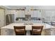 Modern kitchen features white cabinets, quartz countertops, stainless steel appliances, and stylish pendant lighting at 11223 Wescott Hill Dr, Huntersville, NC 28078