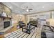 Inviting living room with stone fireplace, hardwood floors, comfortable seating, and open access to kitchen area at 11223 Wescott Hill Dr, Huntersville, NC 28078