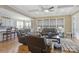 Spacious living room with hardwood floors, coffered ceilings, leather furniture, and open view to the kitchen at 11223 Wescott Hill Dr, Huntersville, NC 28078