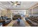 Open concept living room with coffered ceilings, hardwood floors, leather furniture, and view into kitchen at 11223 Wescott Hill Dr, Huntersville, NC 28078