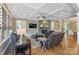 Cozy living room features a stone fireplace, coffered ceilings, hardwood floors, and comfortable leather furniture at 11223 Wescott Hill Dr, Huntersville, NC 28078