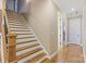 Open staircase featuring hardwood steps, white risers, wood banister, and a well-lit landing at 11223 Wescott Hill Dr, Huntersville, NC 28078