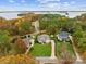 The aerial view captures a beautiful home nestled on a well-manicured lot surrounded by lush trees and a tranquil lake at 117 Yellow Jacket Cir, Mooresville, NC 28117