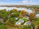 This lakeside home features a pool and backyard, set against the stunning backdrop of a serene lake and colorful fall foliage at 117 Yellow Jacket Cir, Mooresville, NC 28117