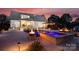 Lavish backyard at night with a pool, spa, and pergola at 117 Yellow Jacket Cir, Mooresville, NC 28117