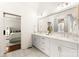 Bright bathroom features dual sinks with white marble counters, gray cabinets, and neutral tile floors at 117 Yellow Jacket Cir, Mooresville, NC 28117