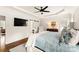 A large primary bedroom with a tray ceiling, hardwood floors and plantation shutters at 117 Yellow Jacket Cir, Mooresville, NC 28117