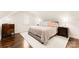 Bright bedroom with neutral decor features hardwood floors and two end tables at 117 Yellow Jacket Cir, Mooresville, NC 28117