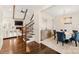 Open floor plan showcasing the dining room with chandelier and blue chairs, seamlessly connecting to living spaces at 117 Yellow Jacket Cir, Mooresville, NC 28117