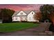 Beautiful exterior view of a modern farmhouse with a long driveway and well-manicured lawn surrounded by mature trees at 117 Yellow Jacket Cir, Mooresville, NC 28117