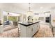 Beautiful kitchen with a large island, stainless appliances, brick floors, and access to outdoor living at 117 Yellow Jacket Cir, Mooresville, NC 28117
