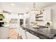 Open kitchen with white cabinets, a spacious island with seating, and stylish lighting for a modern design at 117 Yellow Jacket Cir, Mooresville, NC 28117