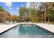 Relaxing outdoor pool area with travertine patio and waterfall feature at 117 Yellow Jacket Cir, Mooresville, NC 28117