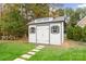 Shed in backyard with gray trim and doors at 117 Yellow Jacket Cir, Mooresville, NC 28117