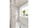 Elegant marble shower boasts designer tile accents, a window, and chrome fixtures at 117 Yellow Jacket Cir, Mooresville, NC 28117