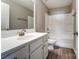 This bright bathroom has a white vanity, a large mirror, a toilet, and a shower and bathtub at 129 Woodbridge Cir, Mount Holly, NC 28120