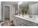 Double sink vanity with white countertops and wood look floor at 129 Woodbridge Cir, Mount Holly, NC 28120