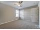 This bedroom is bright with a ceiling fan, a window for natural light, and neutral walls and carpet at 129 Woodbridge Cir, Mount Holly, NC 28120
