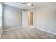 This bedroom offers neutral carpet, plenty of space, a ceiling fan, and a window for natural light at 129 Woodbridge Cir, Mount Holly, NC 28120