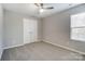 Cozy carpeted bedroom features a ceiling fan and a window that provides natural light and fresh air at 129 Woodbridge Cir, Mount Holly, NC 28120