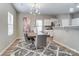 Open dining area with a gray rug, table and stylish decor at 129 Woodbridge Cir, Mount Holly, NC 28120
