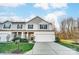 Charming two-story home with a two-car garage and manicured lawn with stone accents and professional landscaping at 129 Woodbridge Cir, Mount Holly, NC 28120