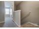 Carpeted hallway with a glimpse into a brightly lit room at 129 Woodbridge Cir, Mount Holly, NC 28120