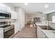 Kitchen area leading to a living room with a ceiling fan at 129 Woodbridge Cir, Mount Holly, NC 28120