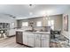 Open kitchen with stainless steel appliances flows into the living and dining area at 129 Woodbridge Cir, Mount Holly, NC 28120